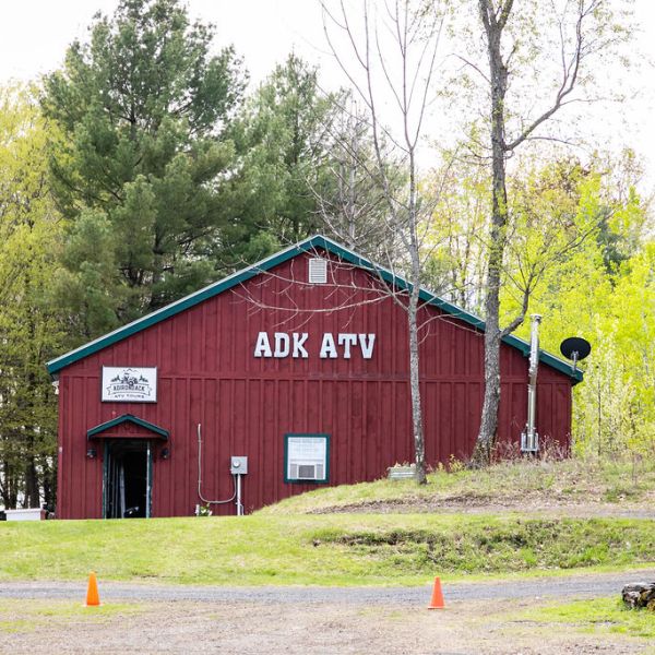 a red barn with trees in the background