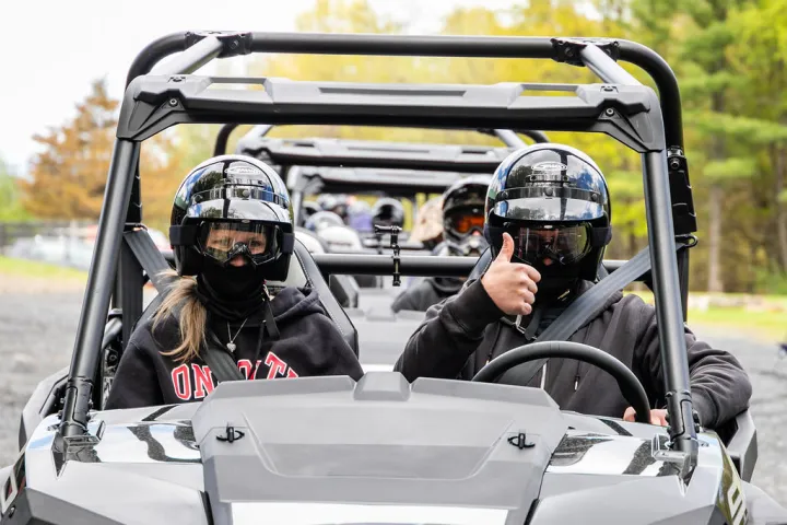 people driving a rzr