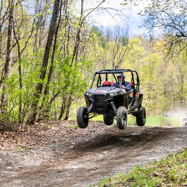 a rzr driving down a dirt road