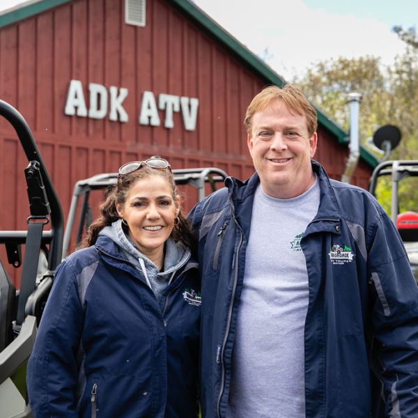 a man and woman standing in front of a building