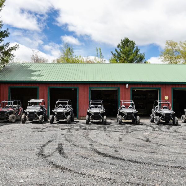 a row of parked rzrs sitting in a parking lot