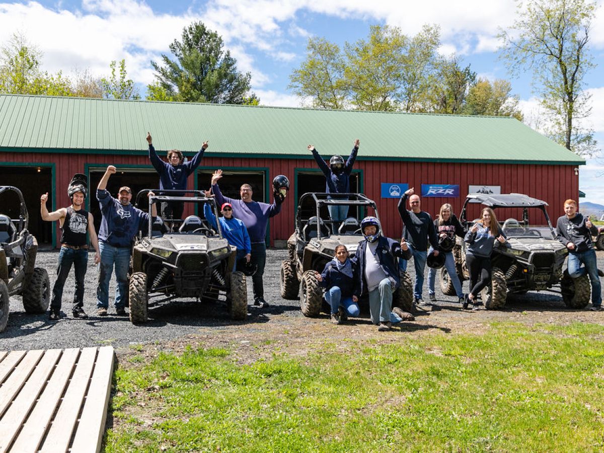 a group of people standing in a parking lot